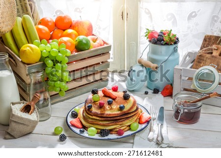 Healthy pancakes with maple syrup and fruits