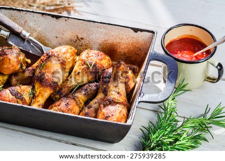 Spicy chicken legs with barbecue sauce in rustic kitchen