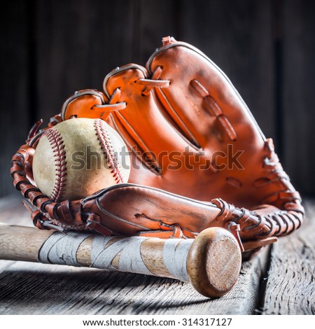 Golden glove and old baseball ball