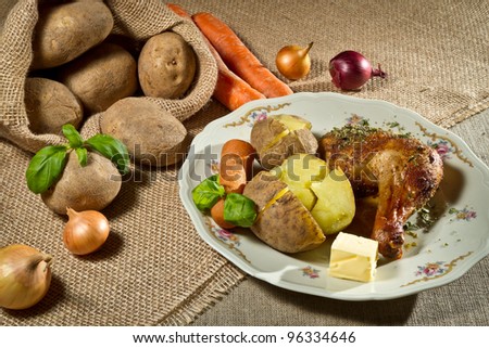 Roasted chicken leg serve with jacket potatoes and vegetables