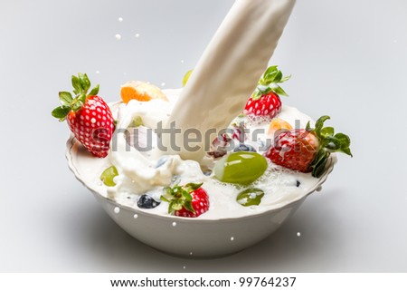 Milk pouring into fresh fruits