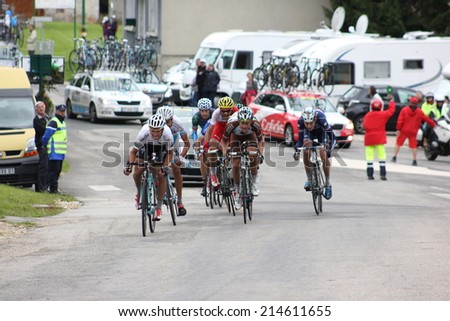 LELEX, FRANCE - AUG 15: Small pack of professional cyclists riding Le Tour de l\'Ain UCI Europe Tour Pro Race on August 15, 2014 in Lelex, Monts du Jura, France. Bert-Jan Lindeman won the race.