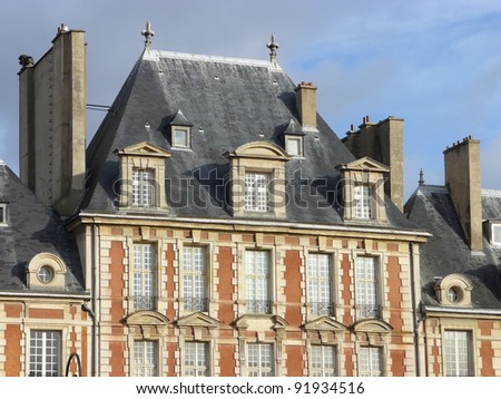 Beautiful buildings of Place des Vosges, square in Paris, France, third arrondissement near Le Marais.