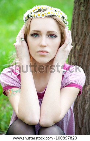 Beautiful alternative woman relaxes daisy field