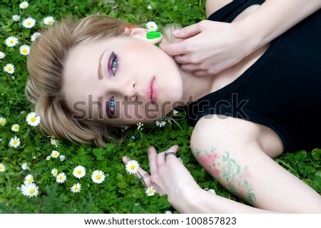 Beautiful  alternative woman enjoying daisy field