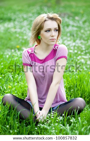 Beautiful alternative woman relaxes daisy field