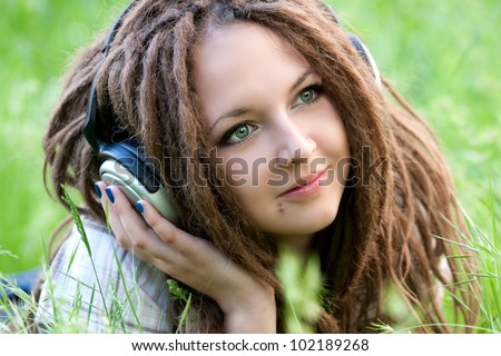 pretty girl with dreads listening to music