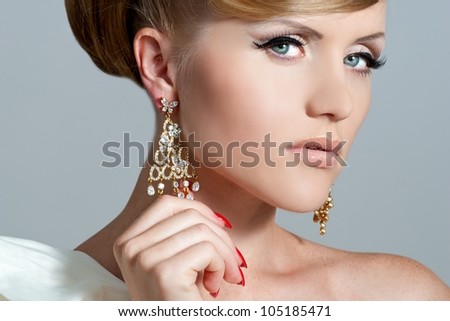 Woman in beautiful earrings. Jewelry and Beauty. A fashion photo