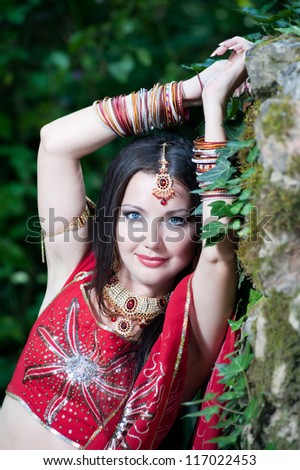 Beautiful young indian woman in traditional clothing with bridal makeup and jewelry. Bride traditionally dressed  in India. Girl bollywood dancer in Sari.