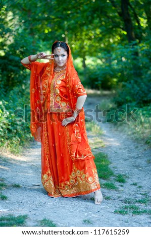 Beautiful young indian woman in traditional clothing with bridal makeup and jewelry. Bride traditionally dressed in India. Girl bollywood dancer in Sari.