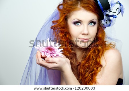 Portrait of a beautiful red-haired girl in a purple hat handmade. Bride