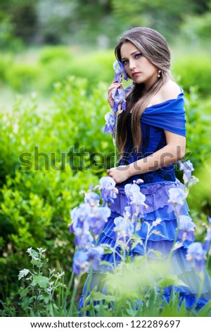 beautiful romantic woman in violet dress in park