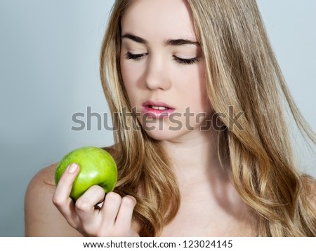 Head shot of woman holding apple