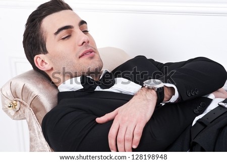 Man in black dinner jacket with bow tie. Bridegroom