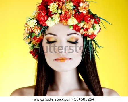 young beautiful woman with yellow wreath of carnations
