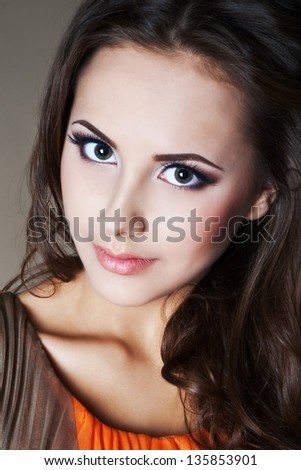 Beautiful woman with evening make-up and evening hairstyle. Jewelry and Beauty. Fashion photo.