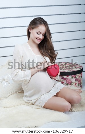 Woman pregnancy with red heart