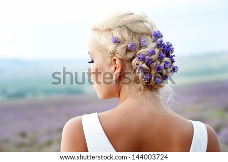 Beauty wedding hairstyle with flowers. Bride