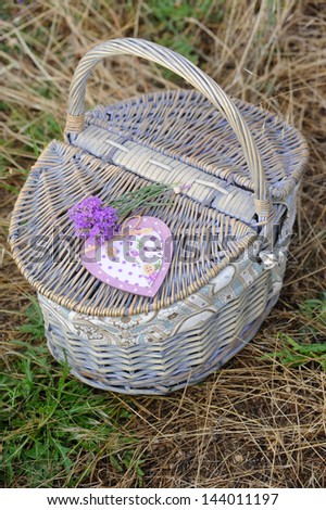 Fresh lavender with a wooden heart on a basket. Provence decor