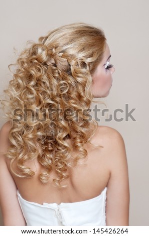 Beauty  curly wedding hairstyle. Bride