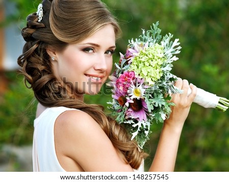 Young Happy Bride With Flower Bouquet