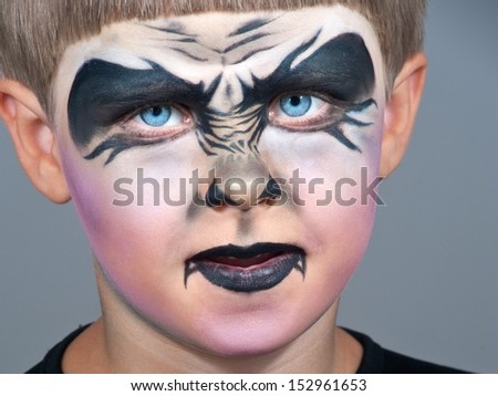 Little boy making face painting. Halloween