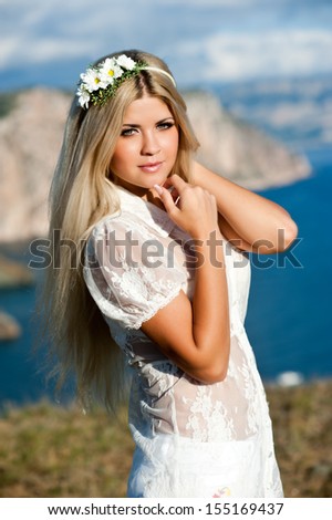 Woman with long  blond hair perfect skin. Young woman outdoors. Bride
