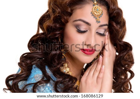 Beautiful young indian woman in traditional clothing with bridal makeup and jewelry. gorgeous brunette bride. Girl bollywood dancer in Sari. Arabian bellydancer