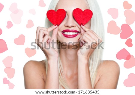 Valentine's Day. Beautiful blond woman with heart in his hands. Young woman with red heart on white background