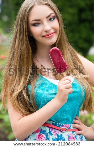 girl excited and happy eating ice cream cone on beach during summer vacation.