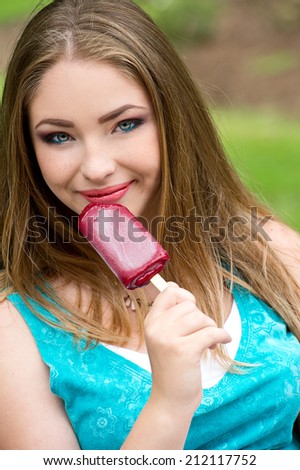 girl excited and happy eating ice cream cone on beach during summer vacation.