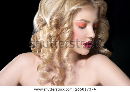 beautiful blonde woman with perfect curly hair. Woman with bright make up