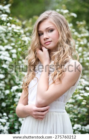 Girl with freckles. Portrait of little girl outdoors in spring