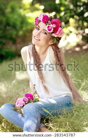 Beautiful girl  in the garden. Soft focus. Beautiful woman with flower wreath