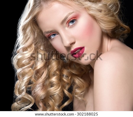 beautiful blonde woman with perfect curly hair. Woman with bright make up