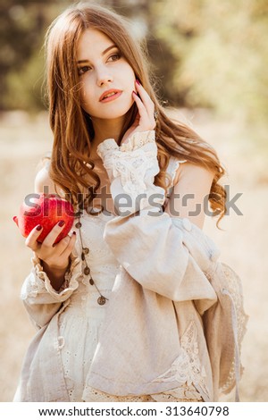 Beautiful woman clothing style boho in autumn outdoor. Woman with red apple