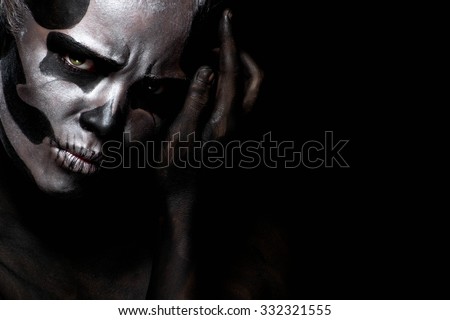 Woman in day of the dead mask skull face art. Halloween face art on black background