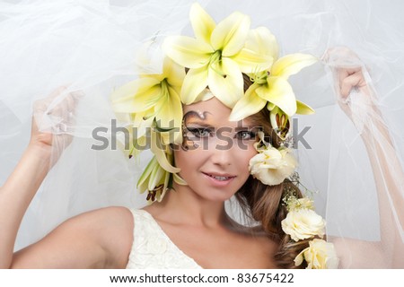 portrait of a beautiful girl with a garland of lilies and eustoma in the head, the bride