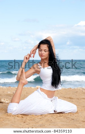 attractive brunette woman in yoga pose. brunette woman in yoga pose and sea
