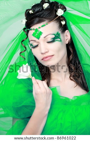 Beautiful brunette with amazing  hairstyle.The bride in the green dress