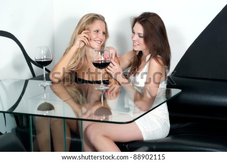 Two girlfriends with two glasses of wine