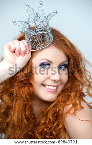 Portrait of beautiful woman with stylish makeup and a crown on a head
