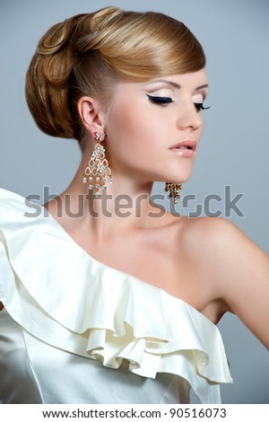 Woman in beautiful earrings. Jewelry and Beauty. A fashion photo