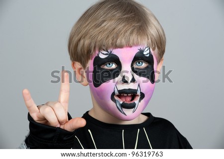 Little boy making face painting. Halloween
