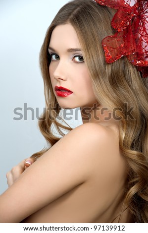 young beautiful girl with red flower in hair