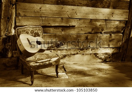 blues guitar on a old chair with wooden background horizontal brown