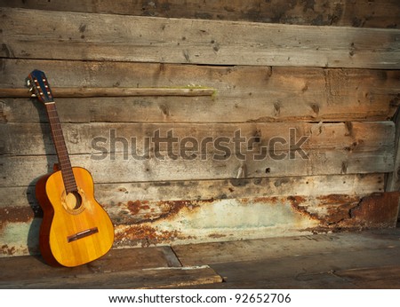 blues guitar the old wooden wall as background horizontal