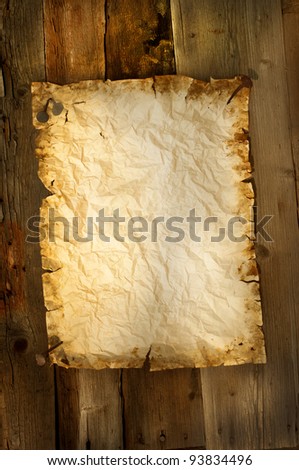 old paper clipped on wood background vertical