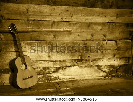 blues guitar the old wooden wall as background horizontal colored