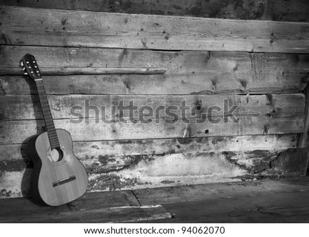 blues guitar the old wooden wall as background horizontal black and white
